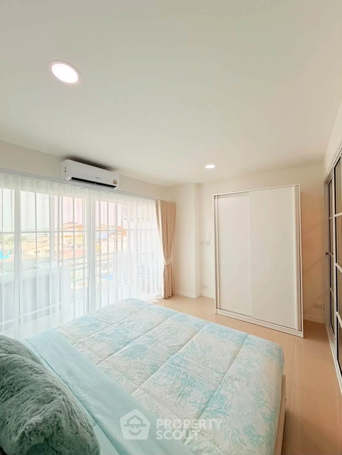 Bright and airy bedroom with large windows and modern decor