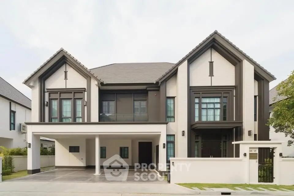 Stunning modern two-story house with elegant facade and spacious driveway in a serene neighborhood.