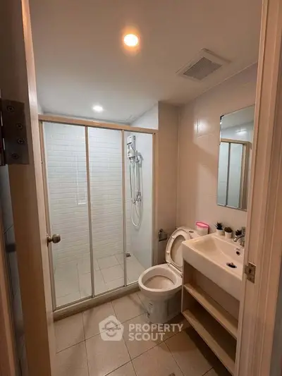 Modern bathroom with glass shower enclosure and sleek fixtures