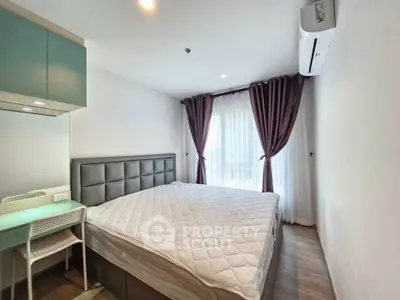 Spacious bedroom with modern decor and natural light, featuring a comfortable bed and stylish curtains.