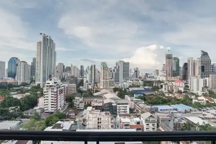 Stunning cityscape view from a high-rise balcony showcasing urban skyline and modern architecture.