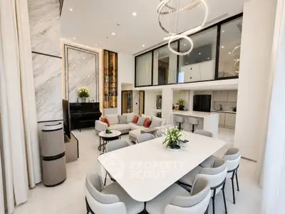 Luxurious open-plan living and dining area with modern kitchen and elegant decor