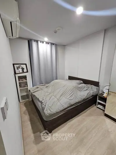 Cozy bedroom with modern decor and natural light, perfect for relaxation and comfort.