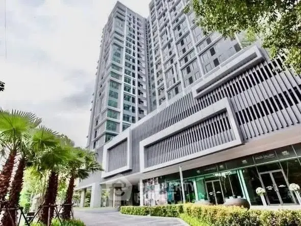 Modern high-rise building with lush greenery and contemporary design.