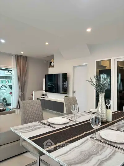 Modern living room with elegant dining setup and sleek decor
