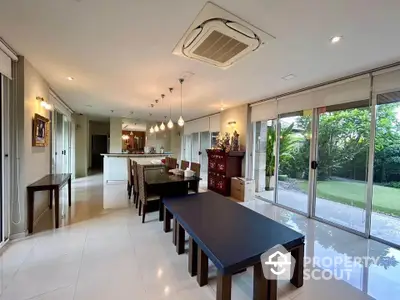 Spacious dining area with garden view and modern lighting in luxury home