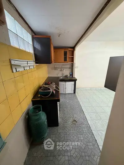 Spacious kitchen with tiled floor and ample storage space