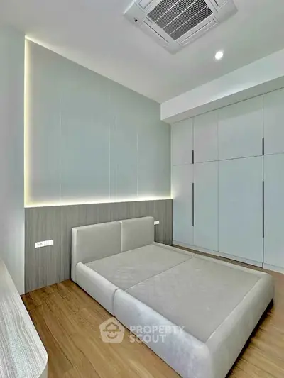 Modern minimalist bedroom with sleek design and built-in storage