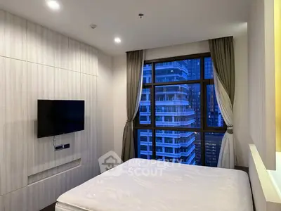Modern bedroom with city view and wall-mounted TV in high-rise apartment