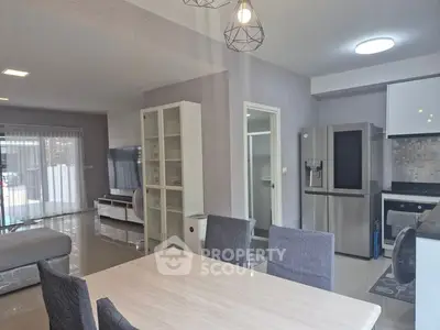 Spacious open-plan living and dining area with modern kitchen and stylish decor.