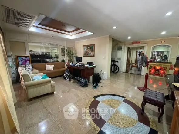 Spacious living room with elegant decor and marble flooring, perfect for family gatherings.