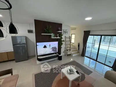 Modern living room with stylish decor, open layout, and large sliding glass doors leading to a balcony.