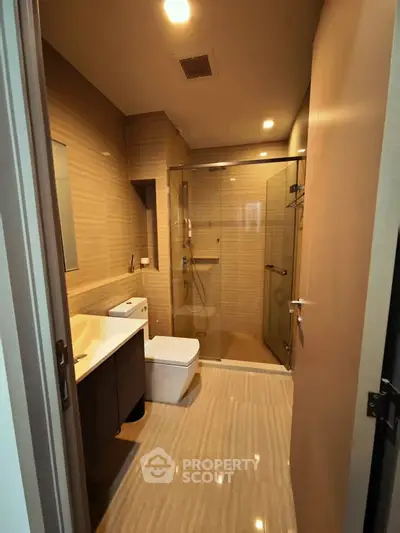 Modern bathroom with glass shower and sleek fixtures