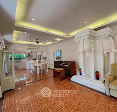 Spacious living room with unique architectural features and modern lighting
