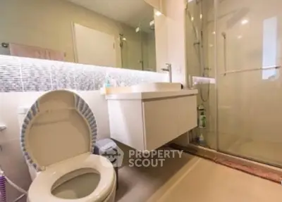Modern bathroom with glass shower and sleek vanity