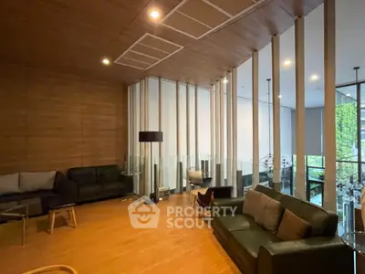 Luxurious modern living room with stylish furniture and floor-to-ceiling windows