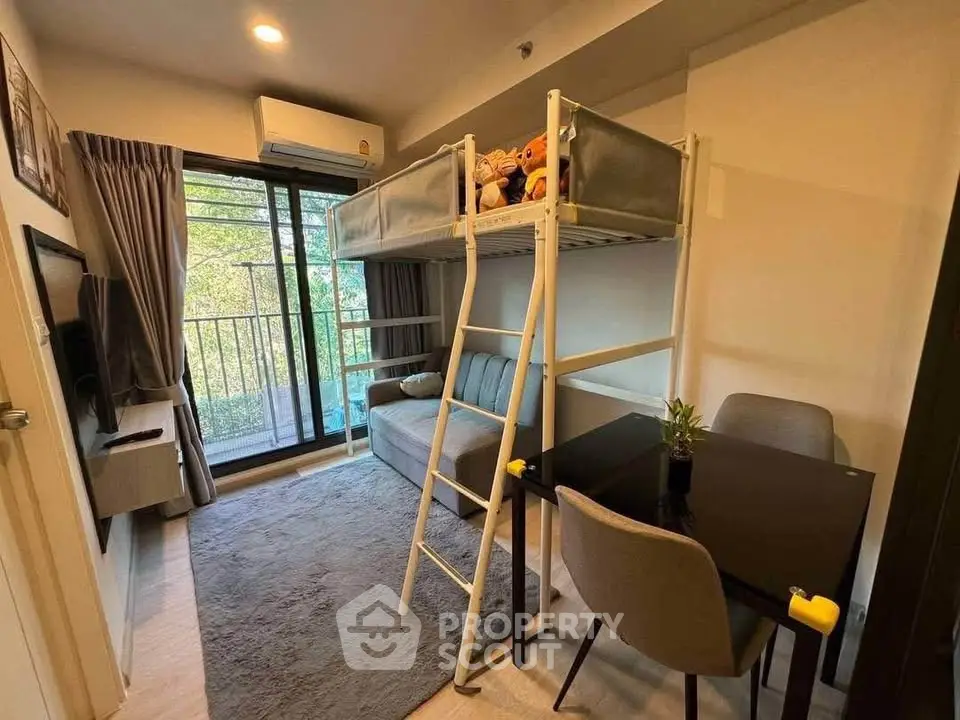 Cozy living room with loft bed and balcony view, perfect for modern urban living.
