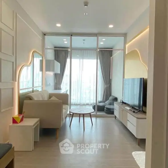 Modern living room with stylish decor and large windows offering natural light and city views.
