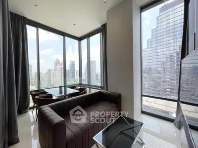 Luxurious corner unit with stunning city views and modern furnishings in a high-rise building.