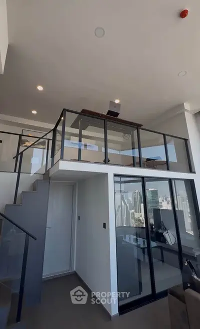 Modern loft apartment with glass railings and city view, featuring a stylish mezzanine and sleek interior design.
