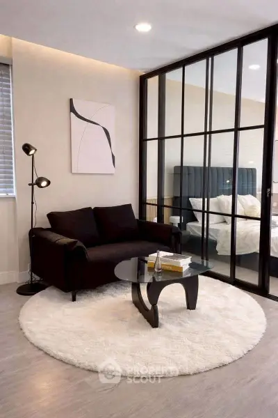 Modern living room with glass partition and cozy decor