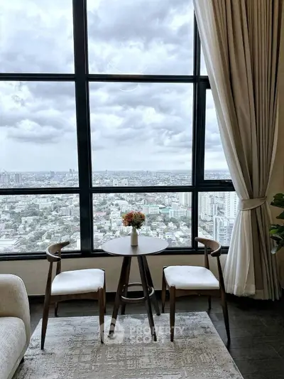 Stunning high-rise living room with panoramic city view and elegant decor.