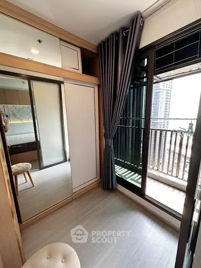 Modern bedroom with balcony view, featuring stylish curtains and sleek wardrobe design.