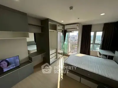 Modern bedroom with balcony and city view, featuring built-in storage and natural light.