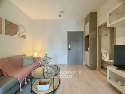 Modern living room with cozy decor and open bathroom view