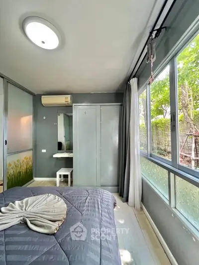 Cozy bedroom with large windows and modern decor