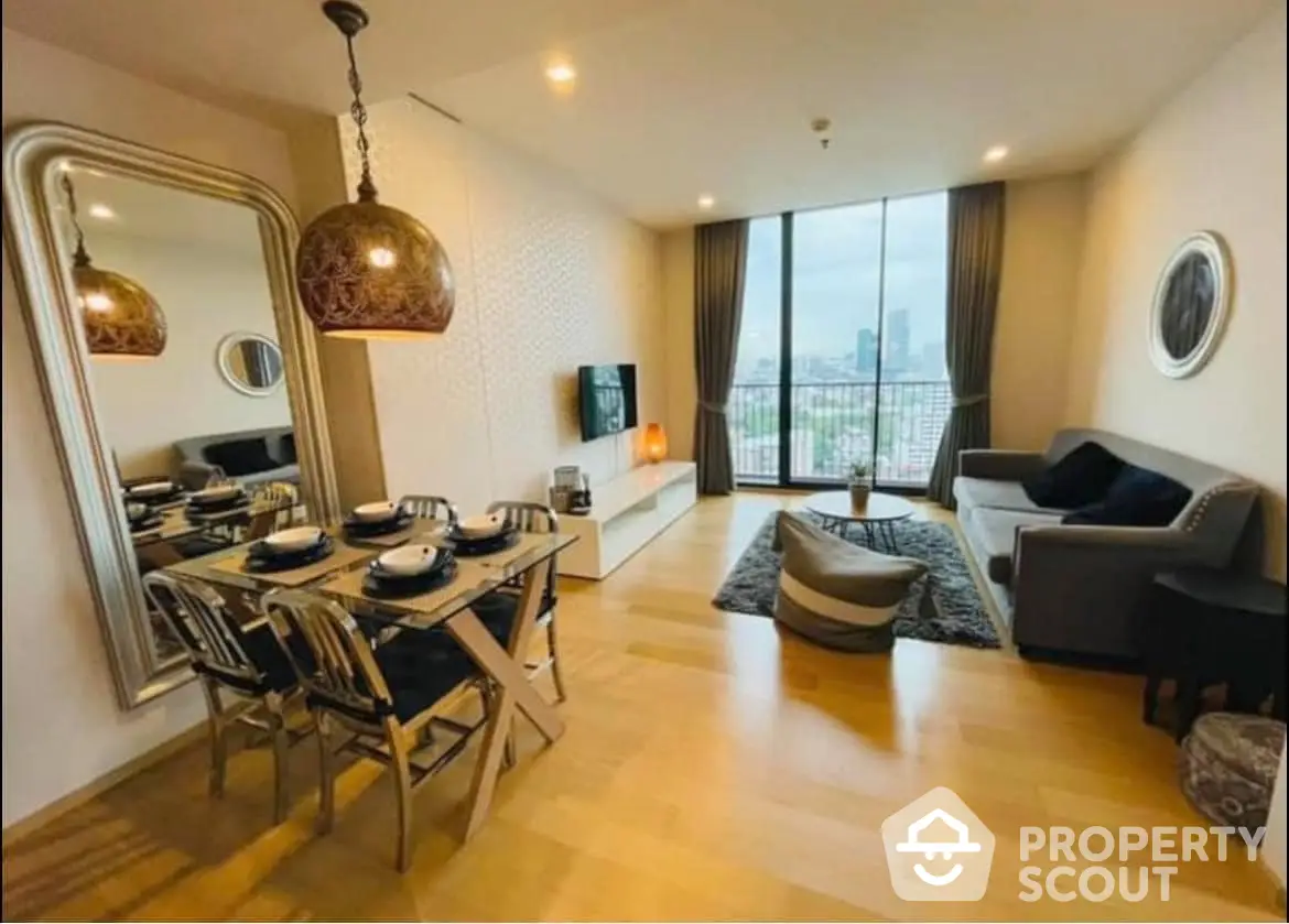 Spacious living room with elegant dining set, modern decor, and large windows offering an abundance of natural light and city views.