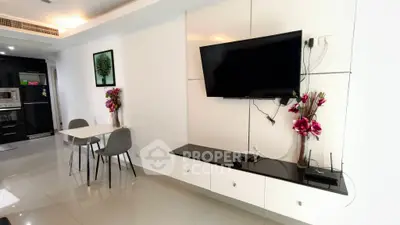 Modern living room with sleek TV setup and stylish dining area