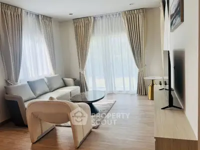 Elegant living room with modern furniture and large windows for natural light.