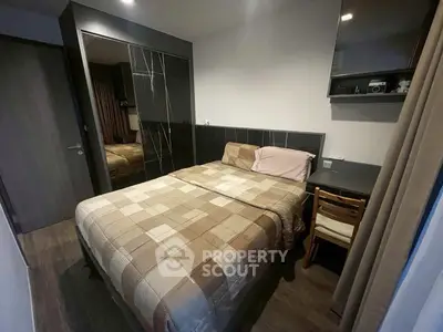 Cozy bedroom with modern decor and comfortable bedding in a stylish apartment.