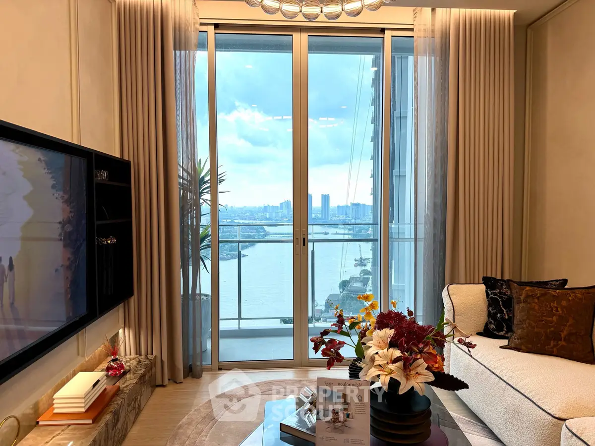 Luxurious living room with stunning city and river view from large balcony, elegant decor and modern furnishings.