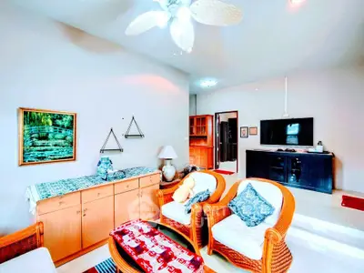 Charming living room with cozy seating and modern decor, perfect for relaxation and entertainment.