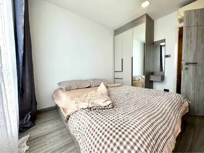 Modern bedroom with stylish decor and ample natural light