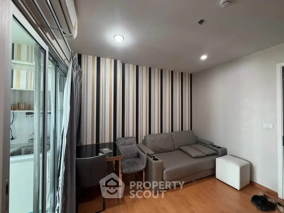 Modern living room with stylish striped wallpaper and cozy seating area