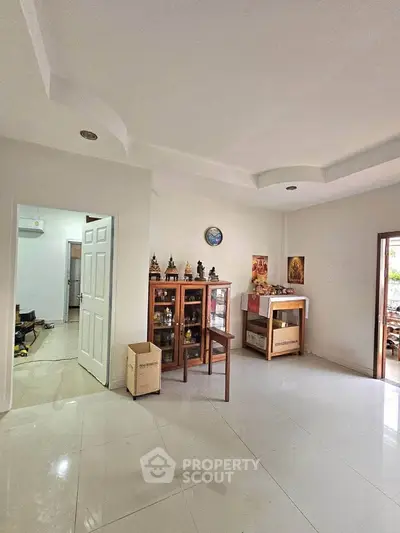Spacious living room with elegant ceiling design and ample natural light