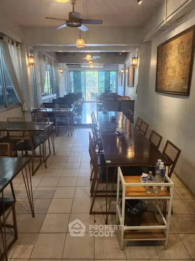 Spacious dining area with elegant decor and large windows offering natural light.