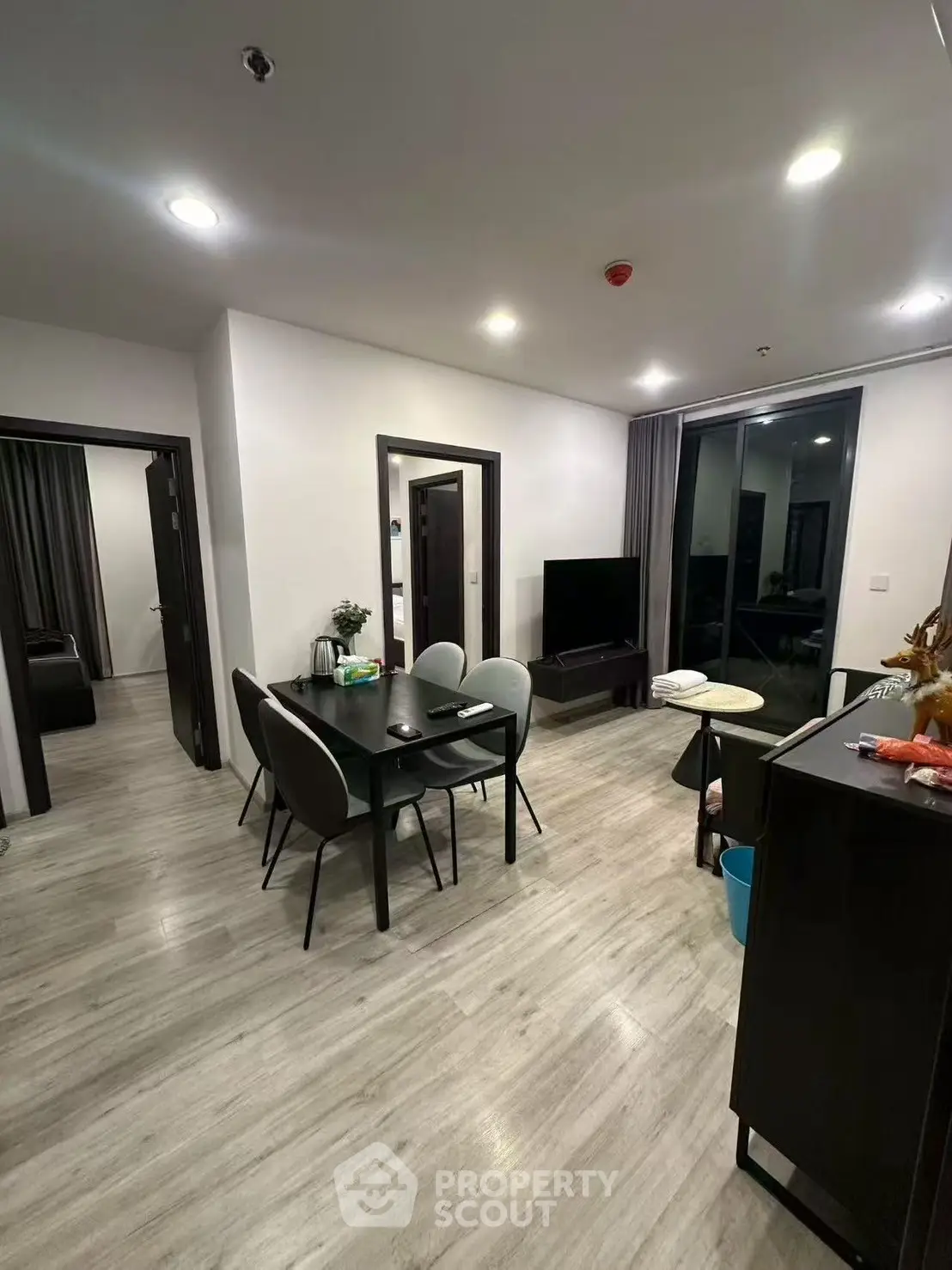 Modern living room with dining area and sleek flooring in a contemporary apartment.