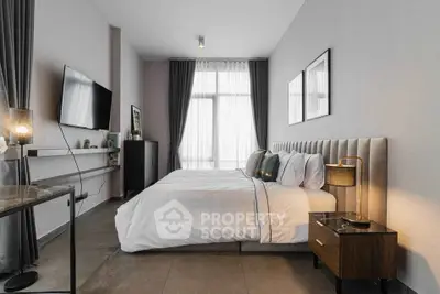 Luxurious modern bedroom with elegant decor and large window for natural light.