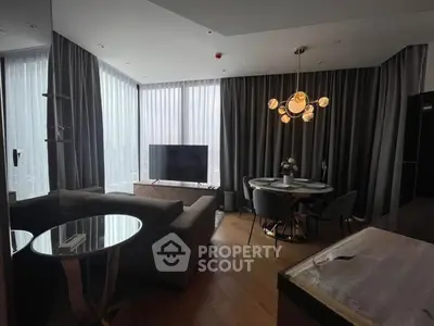 Modern living room with elegant decor and floor-to-ceiling windows offering stunning city views.