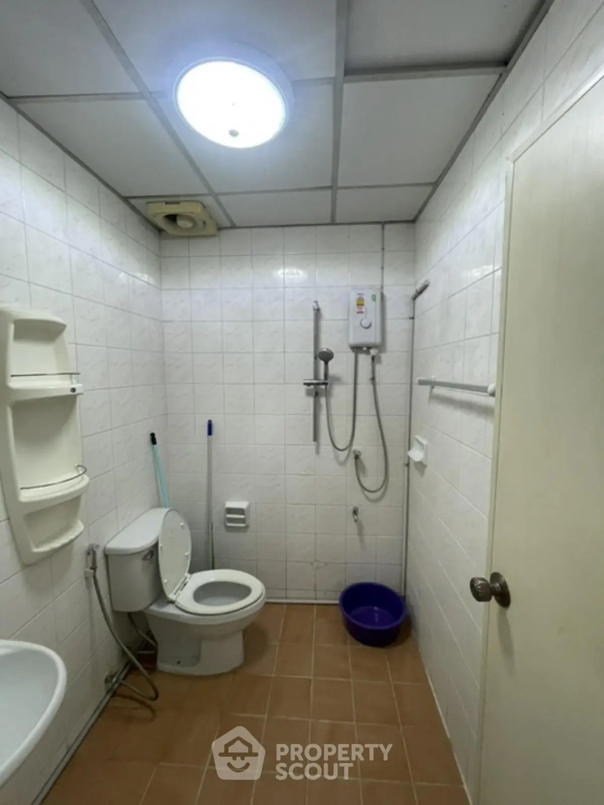Functional bathroom with shower and toilet in tiled interior