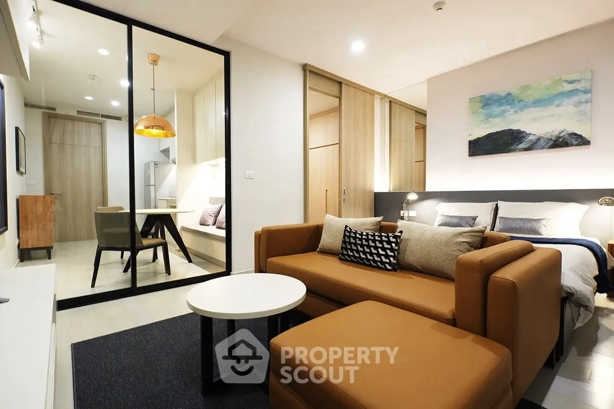 Modern open-plan living room with cozy seating and stylish decor in a contemporary apartment.