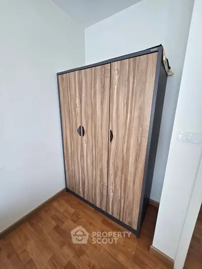 Modern wooden wardrobe in a stylish room with wooden flooring, perfect for organized storage.