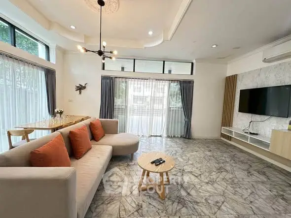 Spacious modern living room with stylish decor and large windows