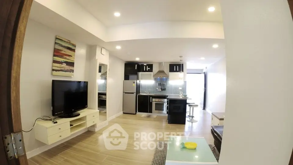 Modern open-plan living room with sleek kitchen and stylish decor
