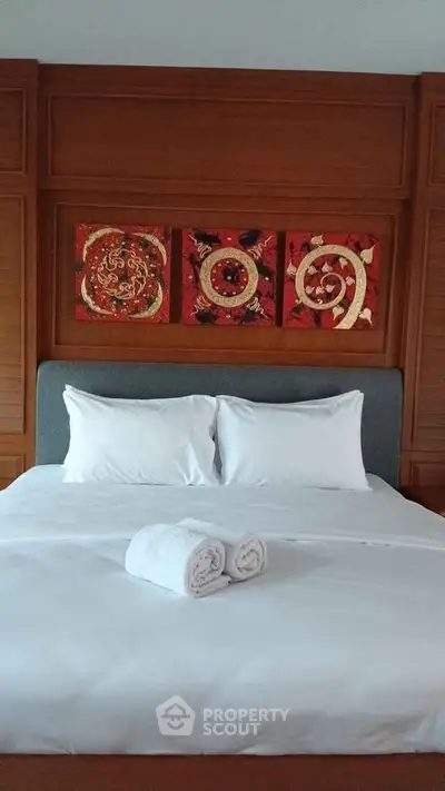 Luxurious bedroom with elegant wooden paneling and artistic wall decor