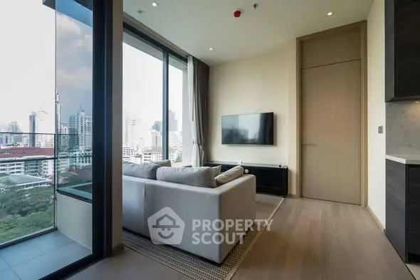 Modern living room with large windows offering stunning city views.